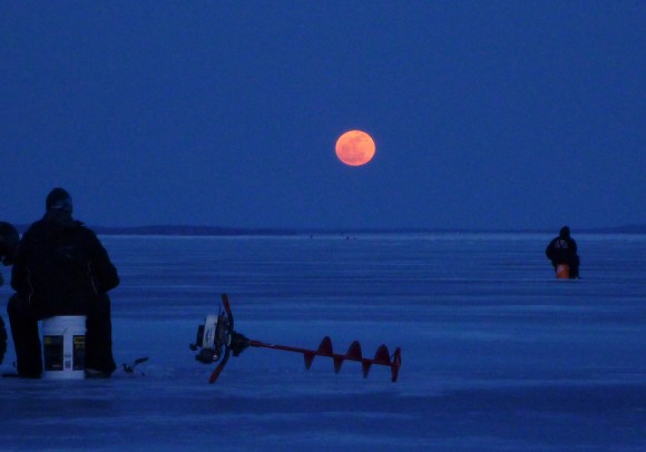 Fishing for walleye on the Bay of Quinte (Lake Ontario) near Belleville, Ontario, when the full Moon appeared through the clouds on the horizon. Credit and copyright: Rick Stankiewicz.